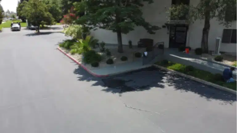 Paved parking lot with landscaping features.