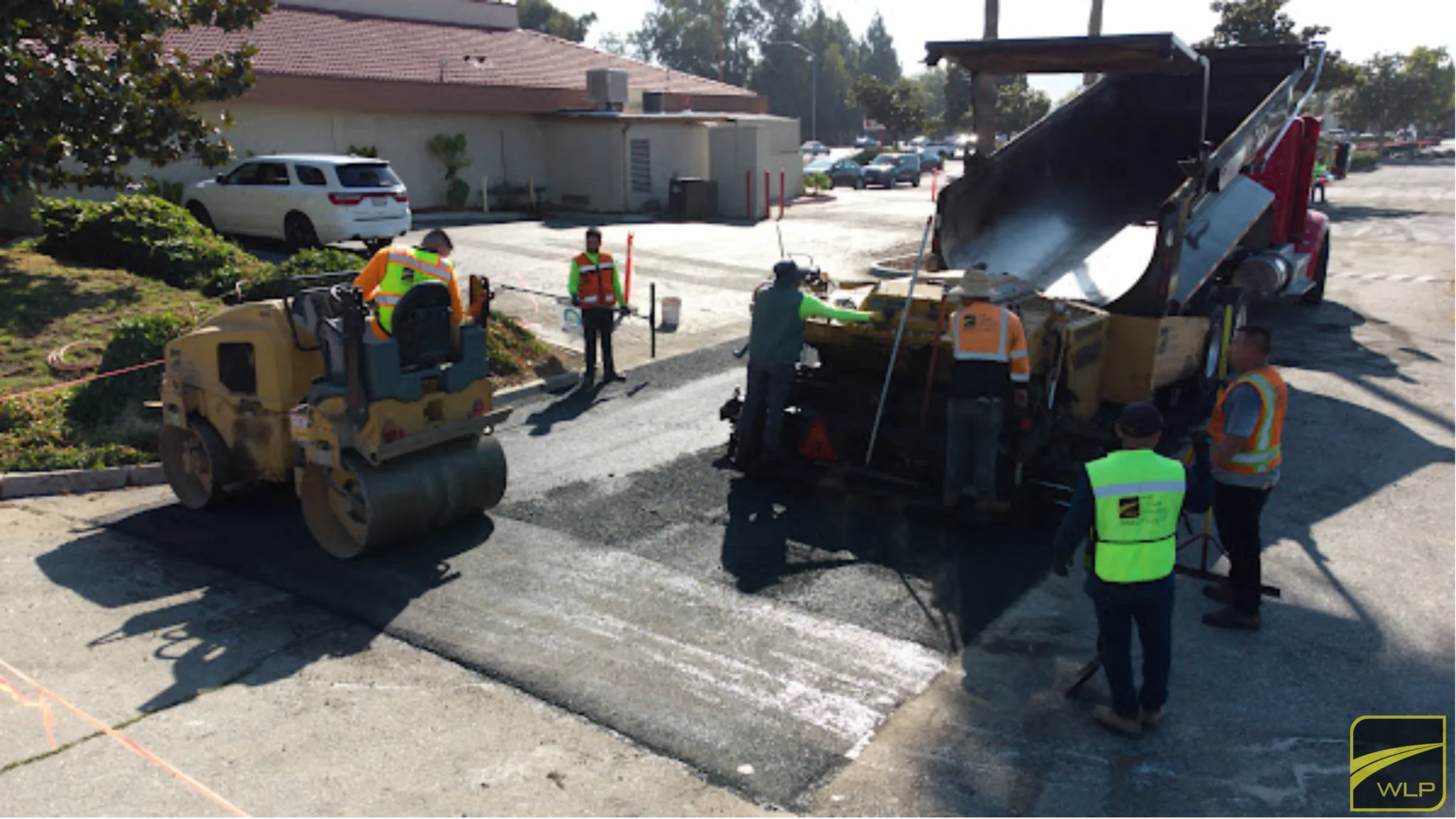Sausalito 2 Workers paving asphalt in a parking lot.