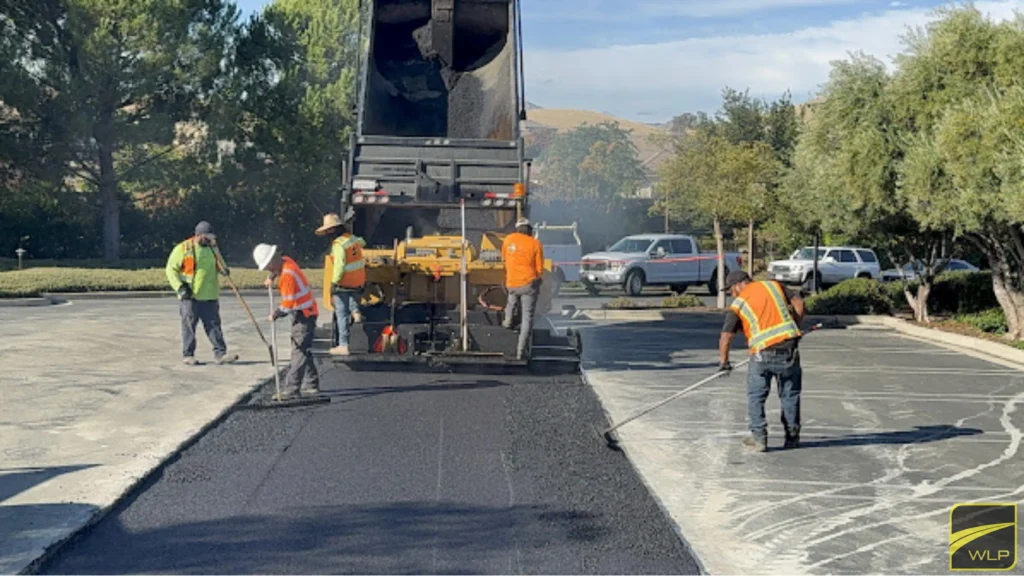 Asphalt Paving 2 Workers paving asphalt in parking lot.