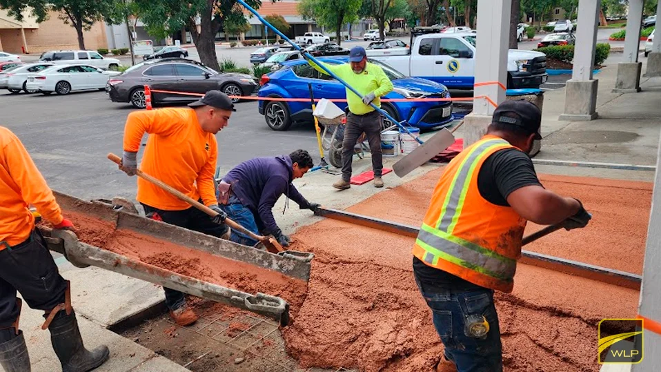 Professional Concrete Paving In California 1 Workers pouring concrete at a site.