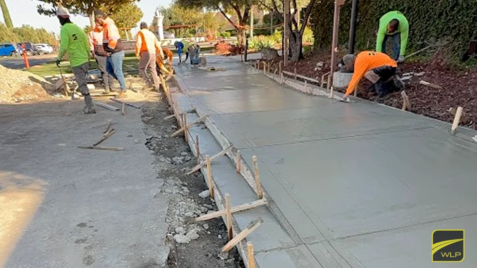 Concrete Contractors 3 Workers pouring concrete for pavement