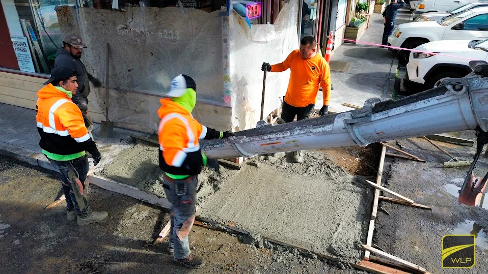 Concrete Contractors 2 Workers pouring concrete on sidewalk