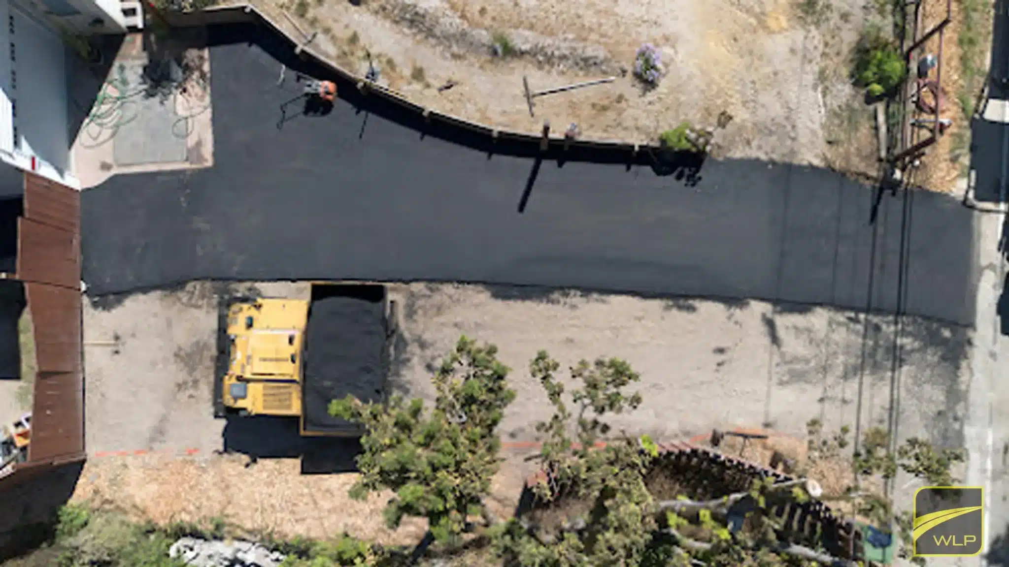 When Was the First Asphalt Road Made? CA & U.S. History 1 Aerial view of asphalt paving process. Project by We Love Paving in California.