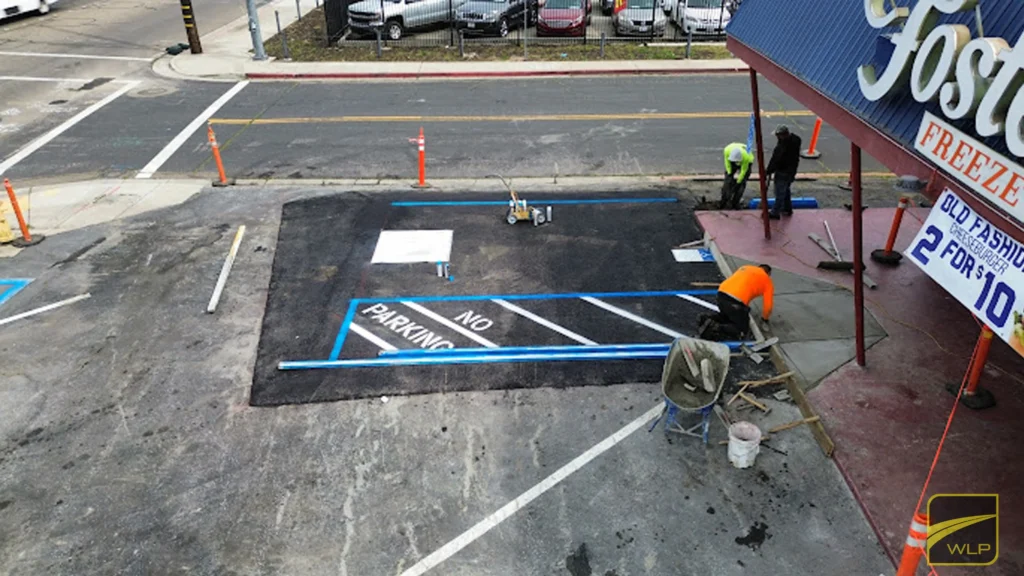 Parking-Lot-Striping-i3 Workers striping a parking lot area.