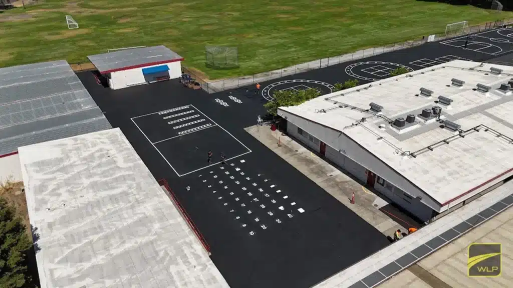 commercial truck parking 2 Aerial view of a school playground with fresh asphalt and white painted games in San Jose. Project by We Love Paving in Northern California, CA.