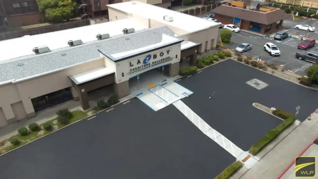 Car Dealership Lot Sealing 1 Aerial view of a freshly paved and striped commercial parking lot in San Francisco California. Project by We Love Paving in Northern California, CA.