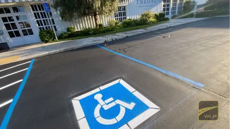 A newly painted blue and white handicap accessibility symbol on fresh black asphalt. Project by We Love Paving in Northern California, CA.