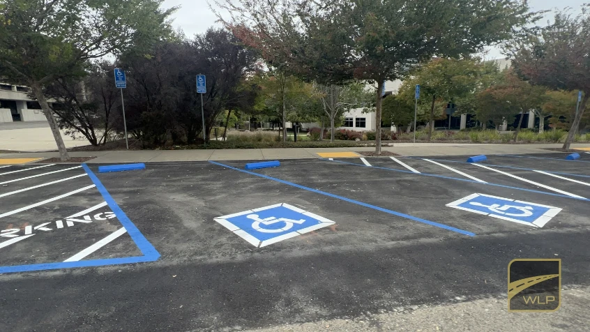 ADA Inspections 2 Newly paved handicap parking spaces with blue markings and accessibility symbols. Project by We Love Paving in Northern California, CA.