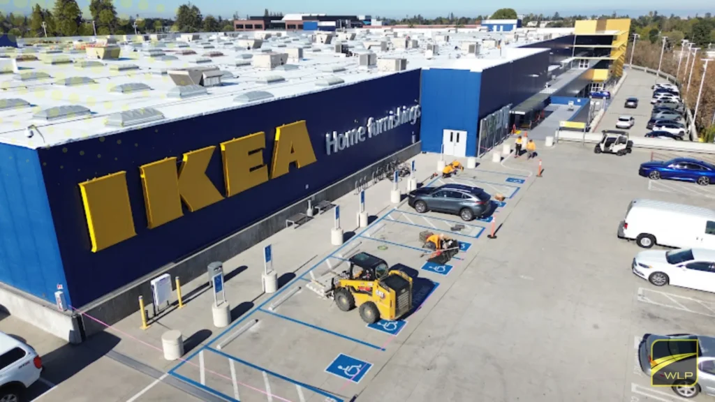 Apartment Complex Parking Lot Paving 1 Aerial view of a construction crew striping new ADA parking stalls at IKEA in Palo Alto CA. Project by We Love Paving in Northern California, CA.
