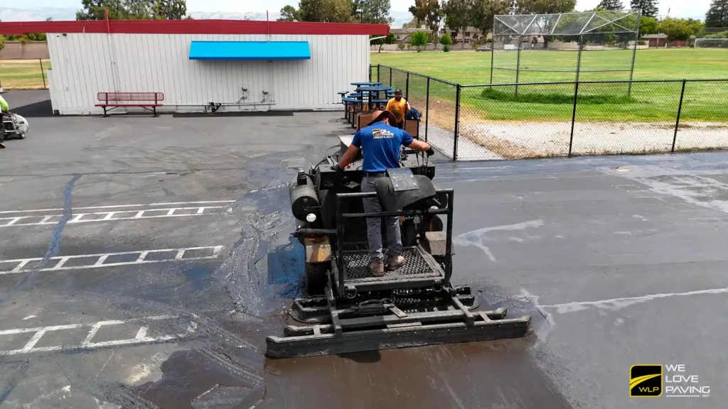 Car Dealership Lot Sealing 4 Paving crew applying asphalt on surface in California