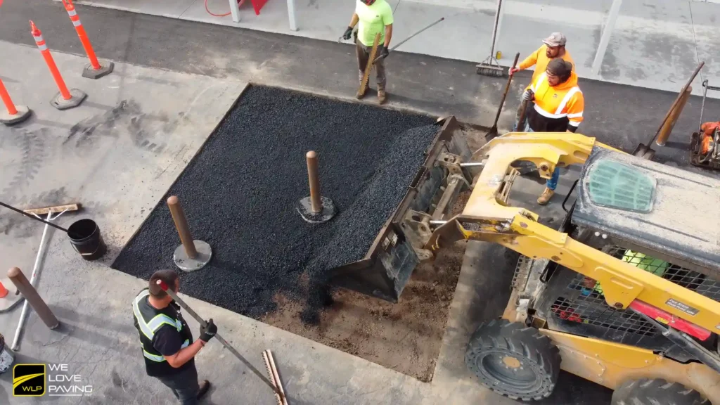 Quick Service Restaurant Pavement Repair Services 4 Workers installing bollards on pavement In California