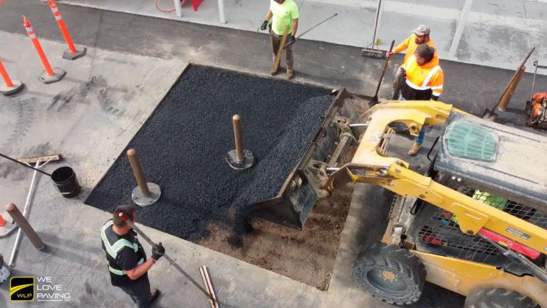 Religious Center Asphalt Paving in California 4 Workers installing bollards on pavement In California