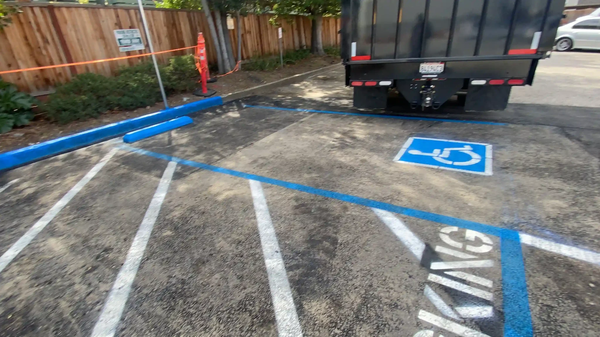 Expert Bollard Installation Near Me 2 Completed blue and white ADA handicap parking stall next to a black service truck.