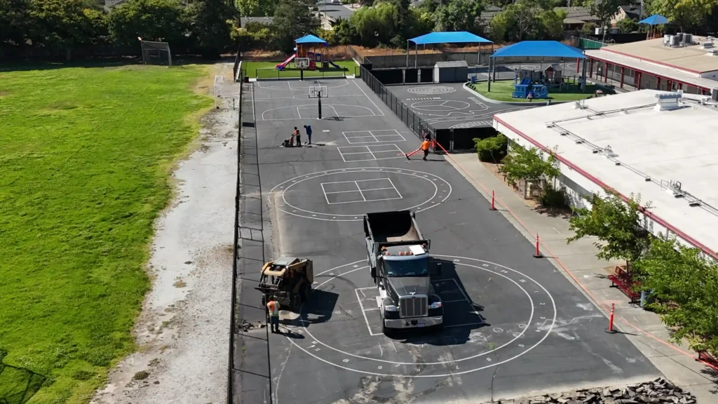 School & University Paving 1 Leveling asphalt base for school sports courts.