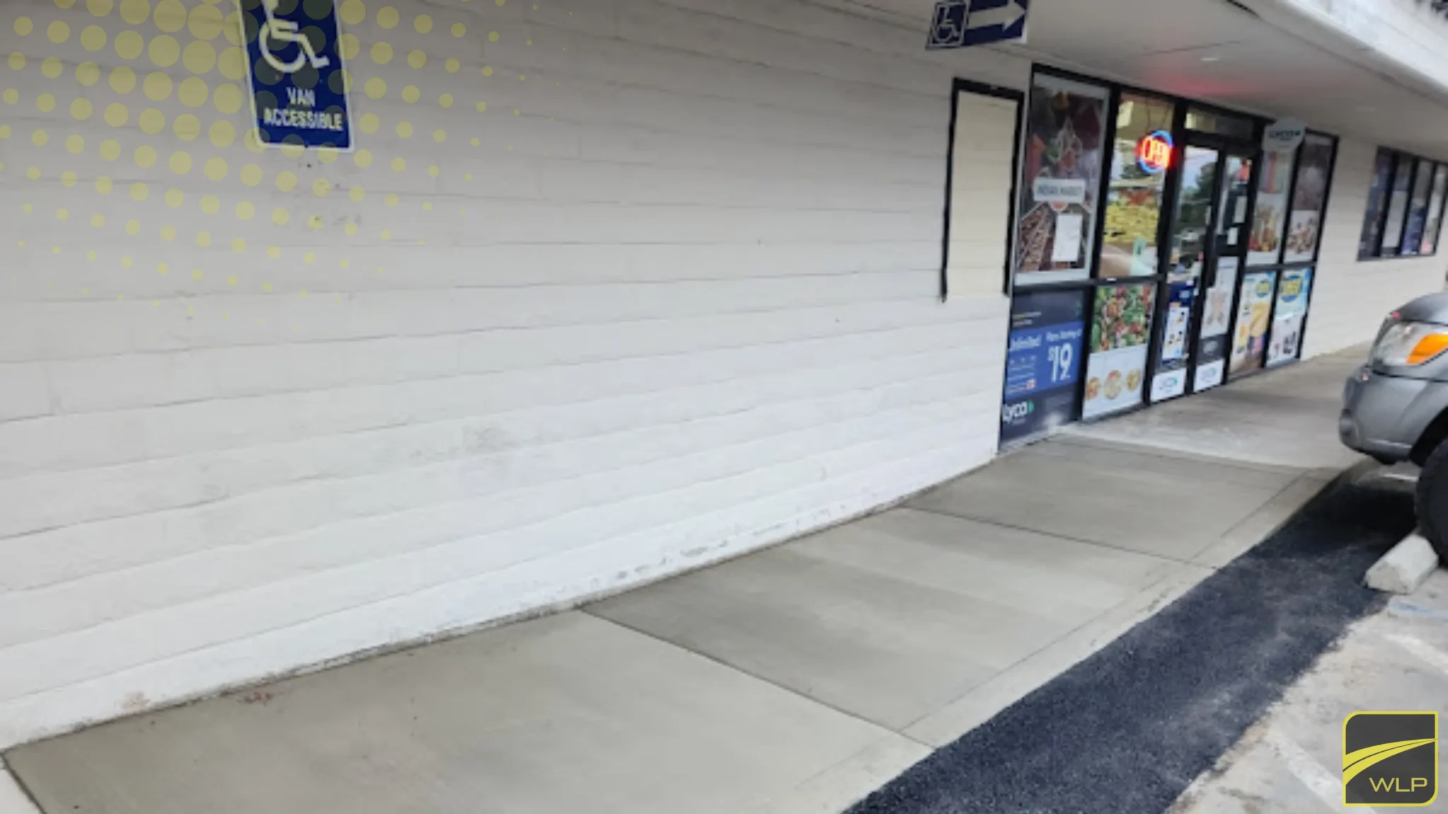 Sacramento Concrete 1 Finished concrete walkway with "Van Accessible" ADA signage and blue-and-yellow pavement markings.