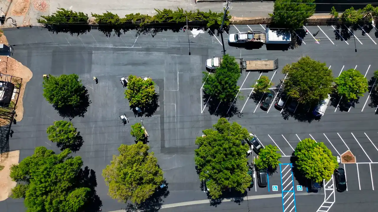 Parking Lot Restriping: How Often, and the Four Events That Decide 1 Overhead view of a freshly sealcoated and restriped commercial parking lot in Northern California