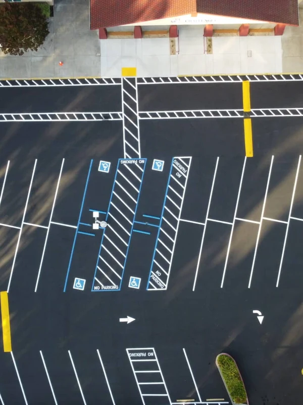 Paving Toolkit 1 Aerial view of a newly striped asphalt parking lot with ADA-accessible stalls